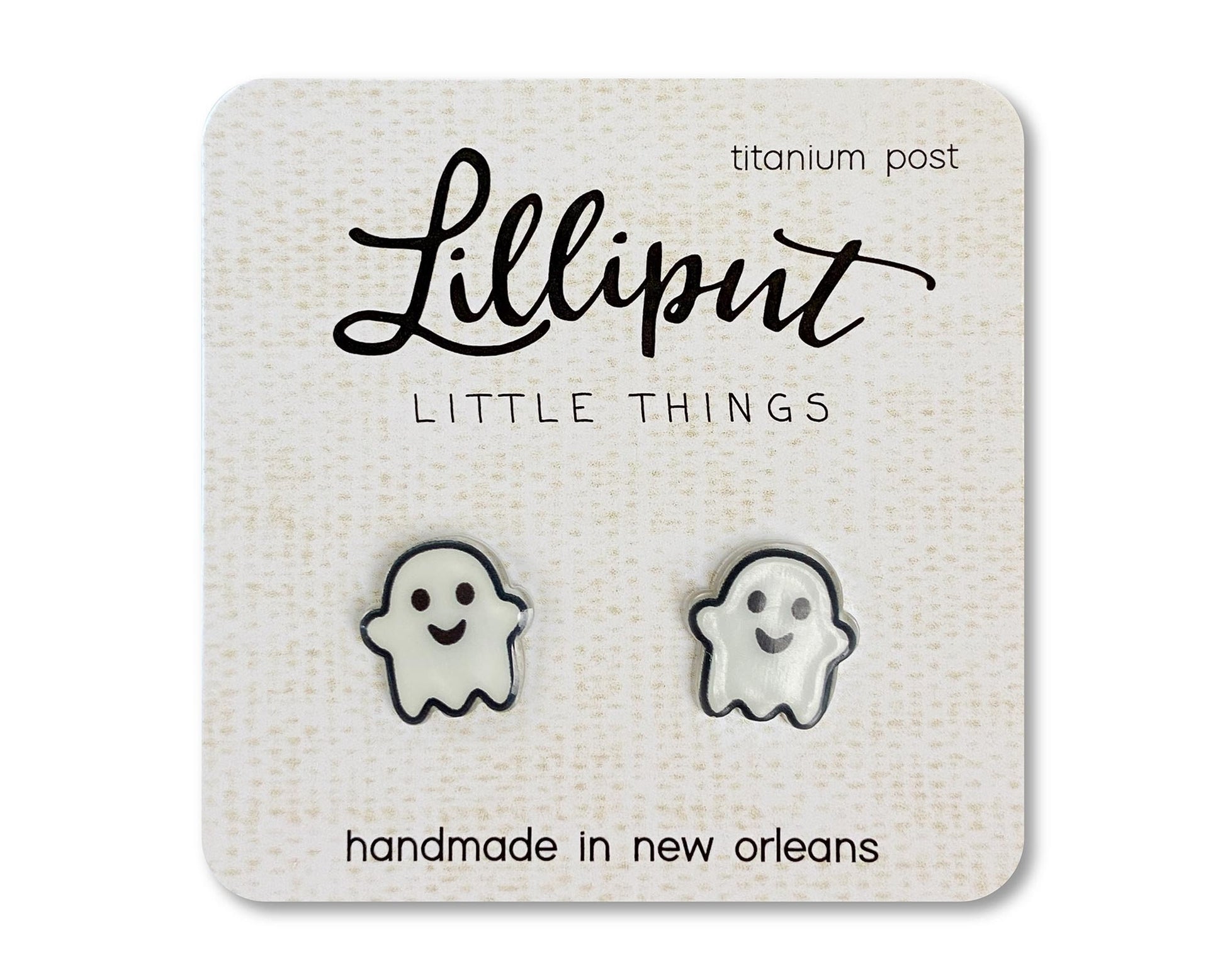 A pair of white kawaii ghost earrings on a beige card with the text 'Lilliput Little Things, handmade in New Orleans, Titanium Post'.