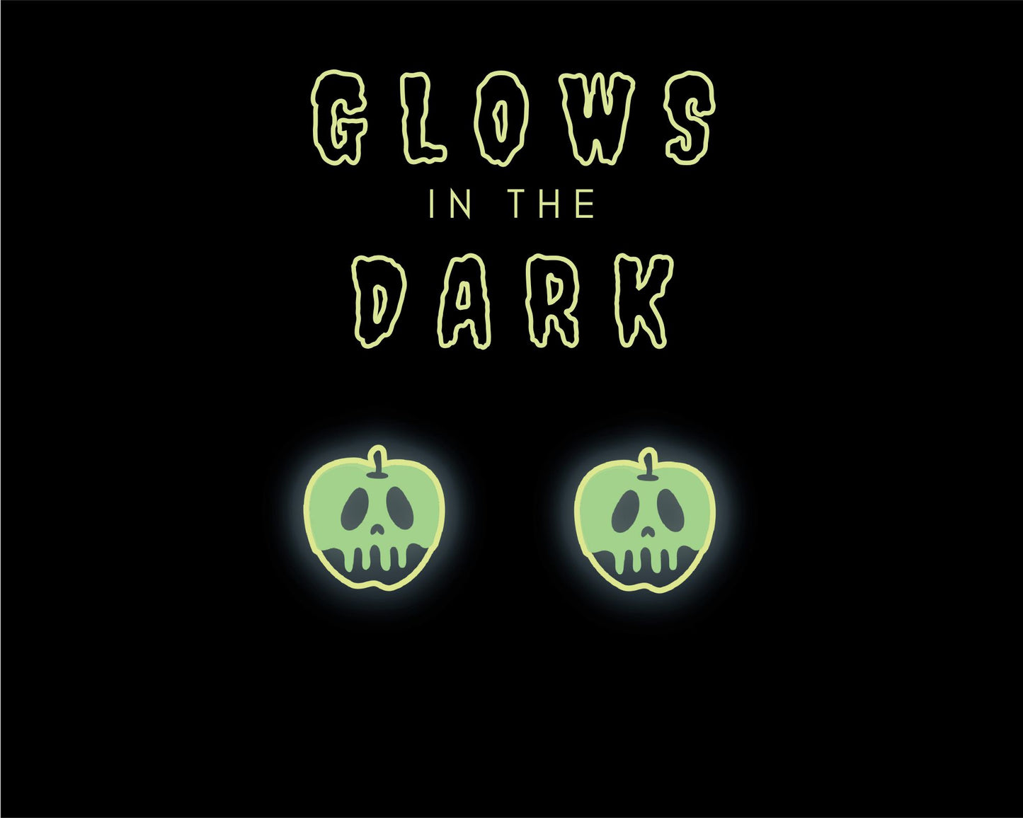 two green apples with skull faces, glowing in the dark against a black background.